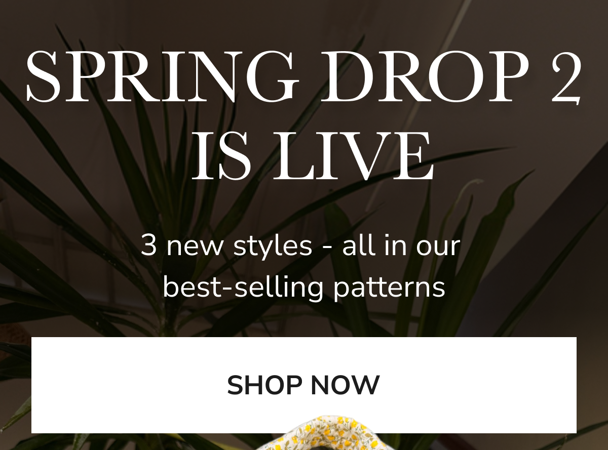 Announcement for Spring Drop 2 with new styles and a 'Shop Now' button.