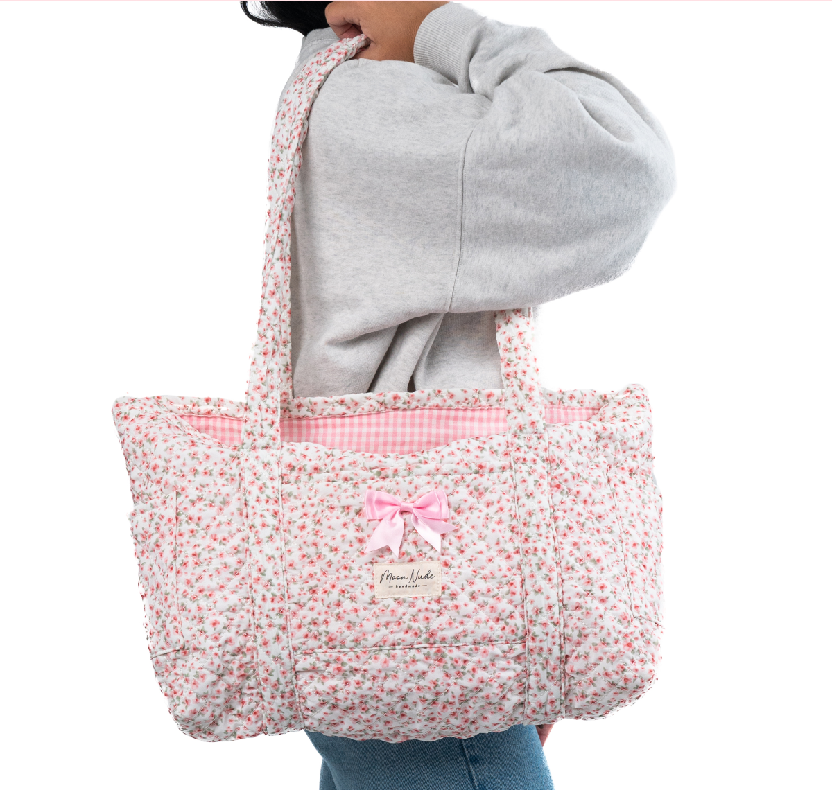 Floral tote bag with pink bow detail.