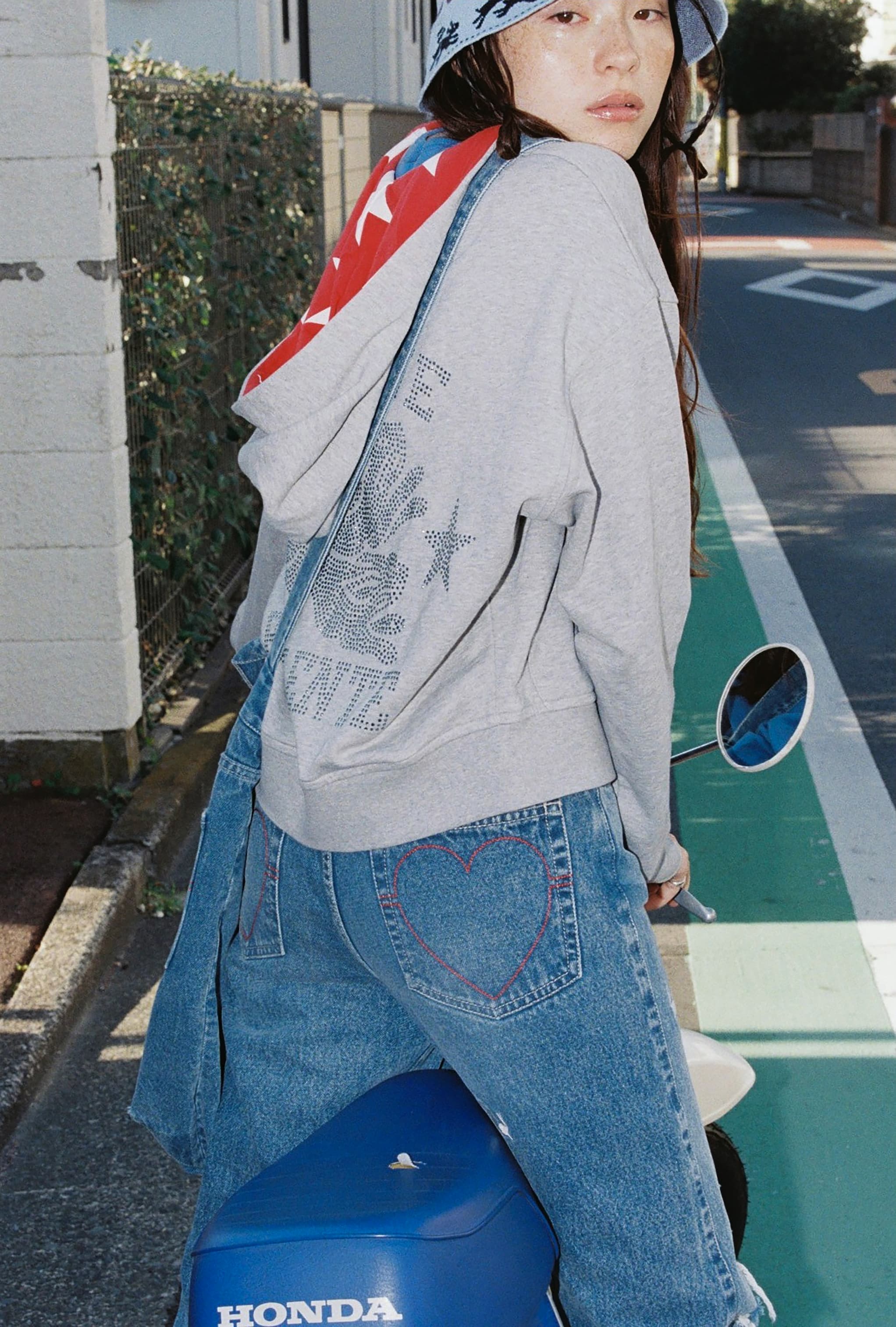 an image of a woman sitting on the curb of a building