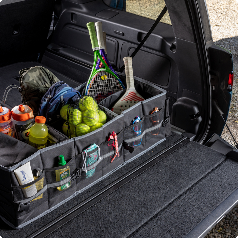 A trunk with soft storage bins holding outdoor gear
