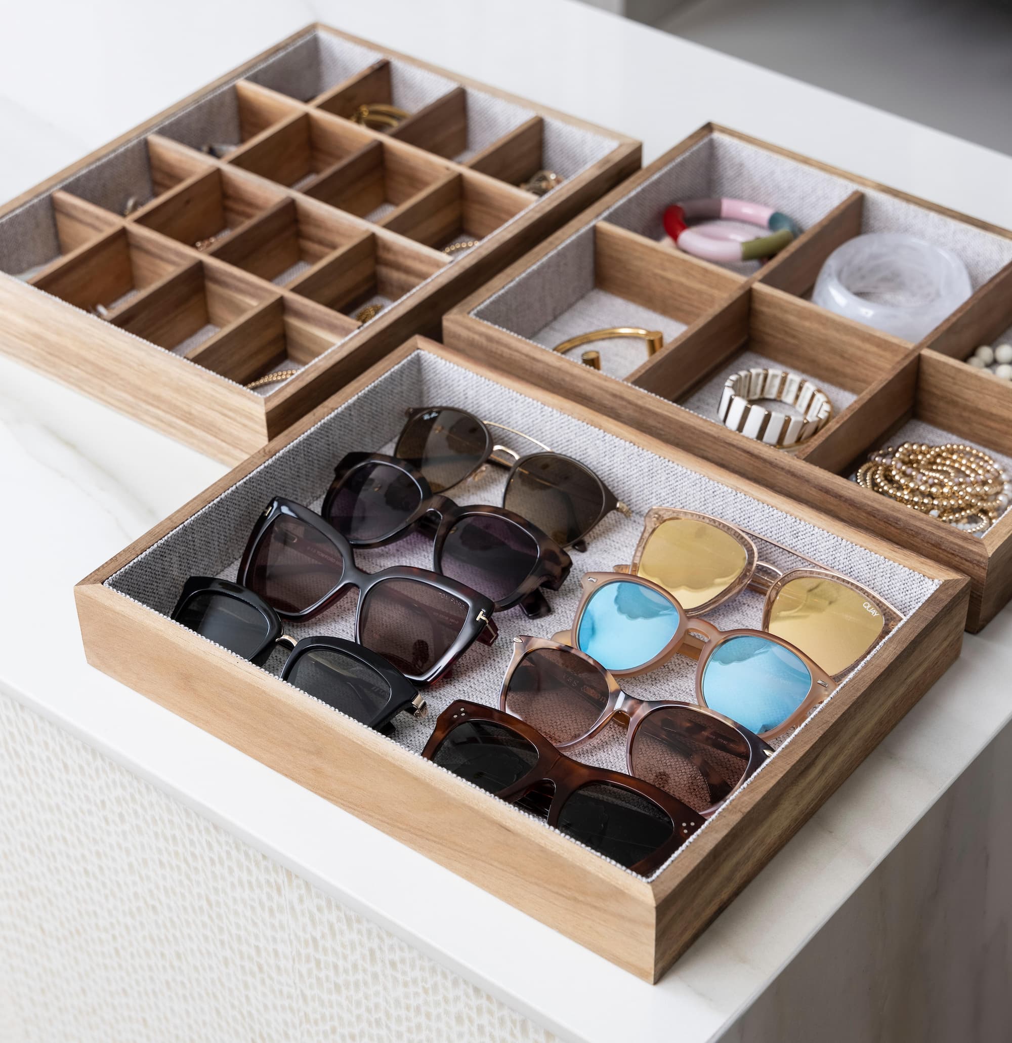 Lined trays holding sunglasses and jewelry