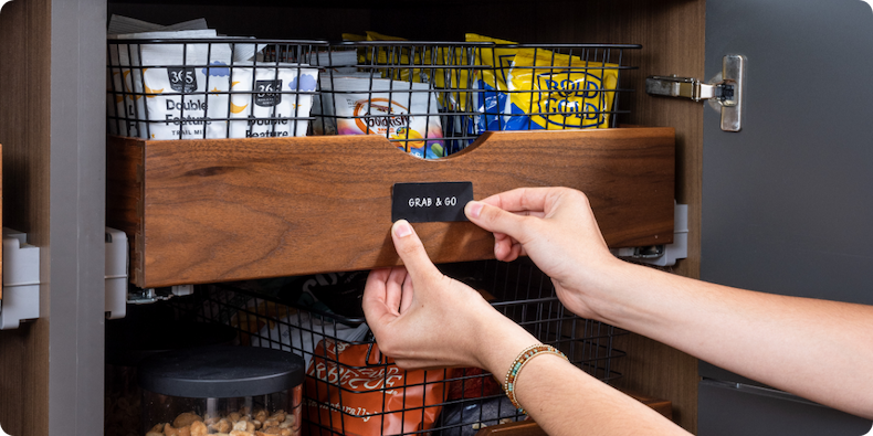 A person labeling a grab & go shelf