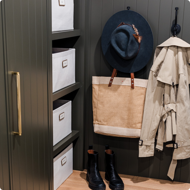 An entryway with hooks and Oxford Bins
