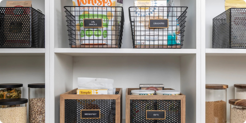 A tidy pantry with a variety of baskets and canisters