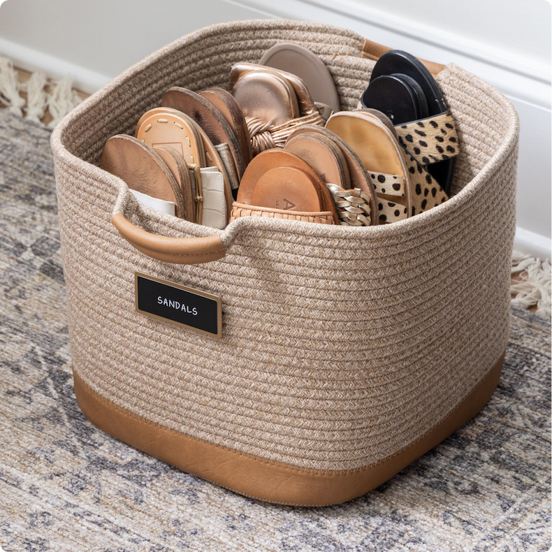 A labeled rope bin holding sandals