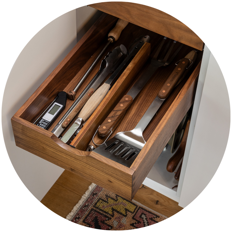 An organized drawer with grilling utensils