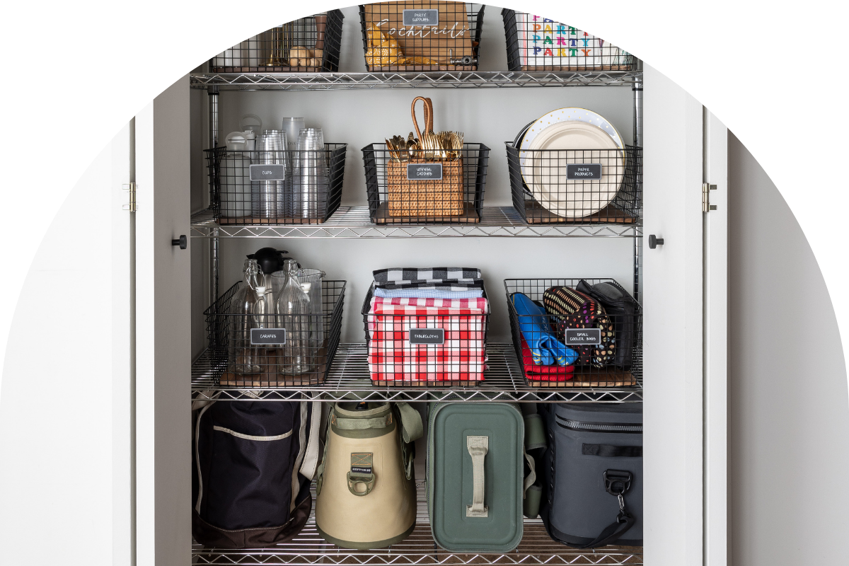 An organized kitchen closet with picnic supplies