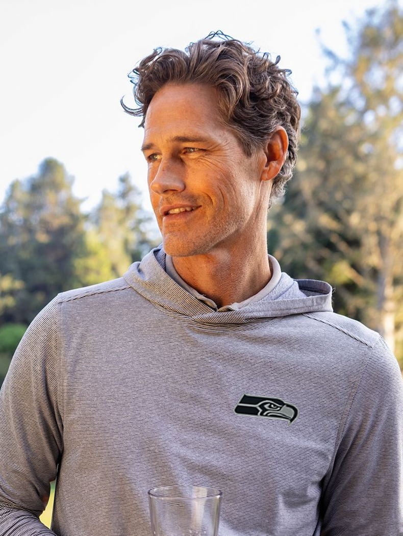 Man wearing Adapt pullover with logo