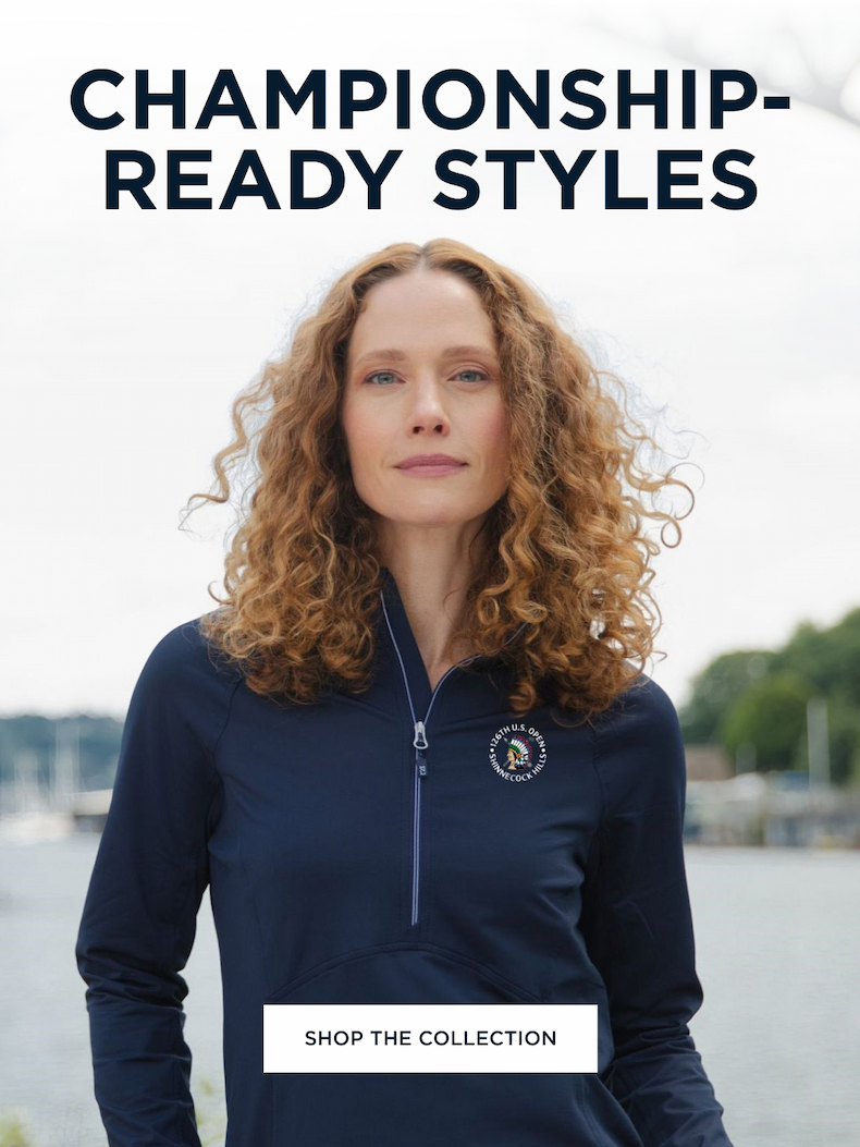 Woman wearing a dark blue quarter zip with the 126th U.S. Open logo