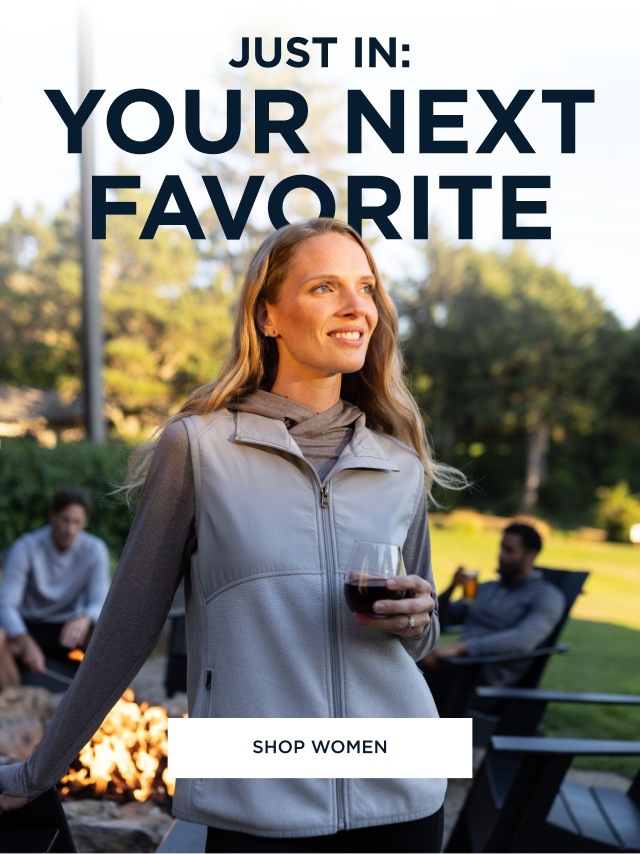 Woman wearing Hunter's Point vest while standing by the fire and drinking wine | Shop Women