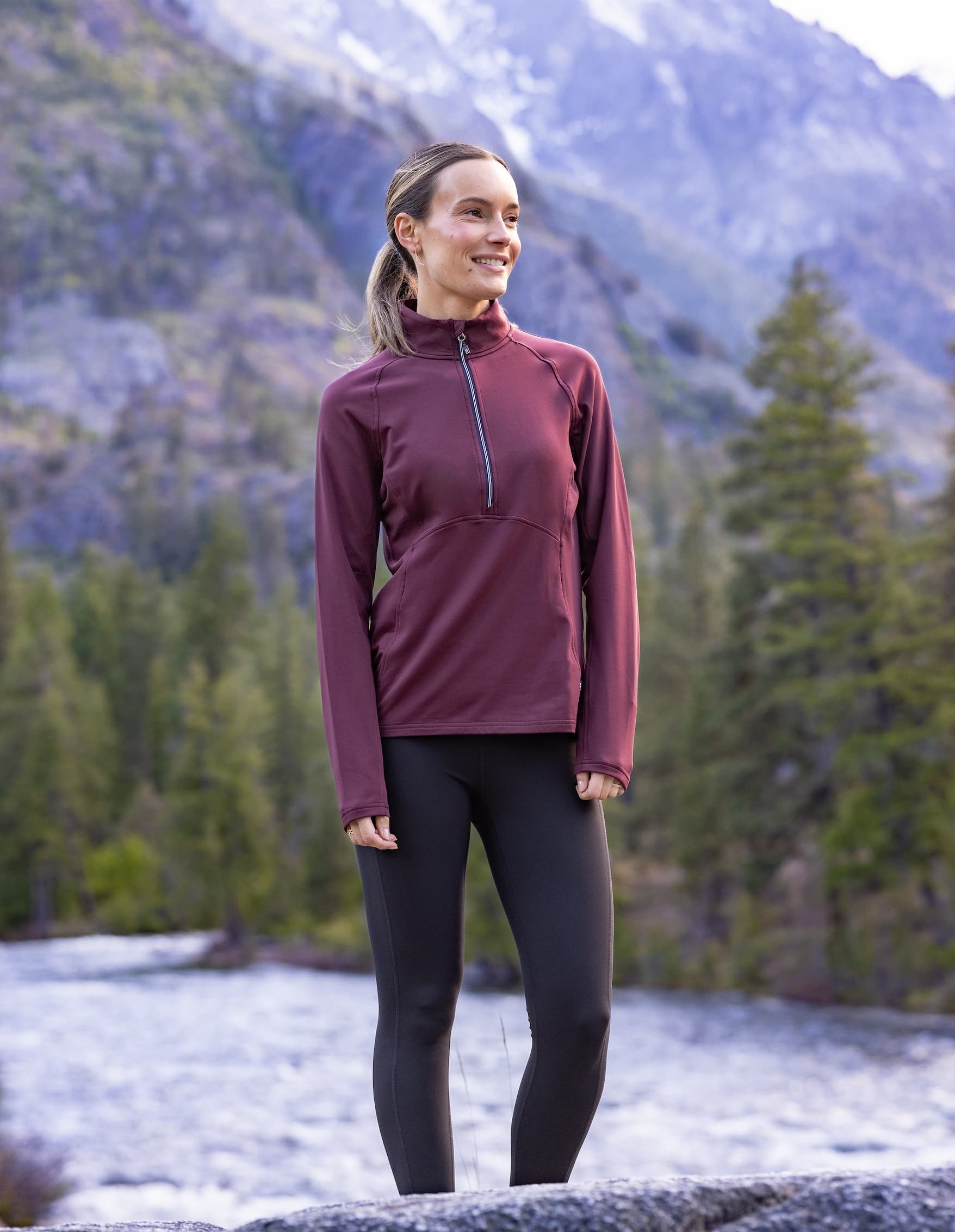 Woman wearing bordeaux colored quarter zip while golfing | Shop New Arrivals