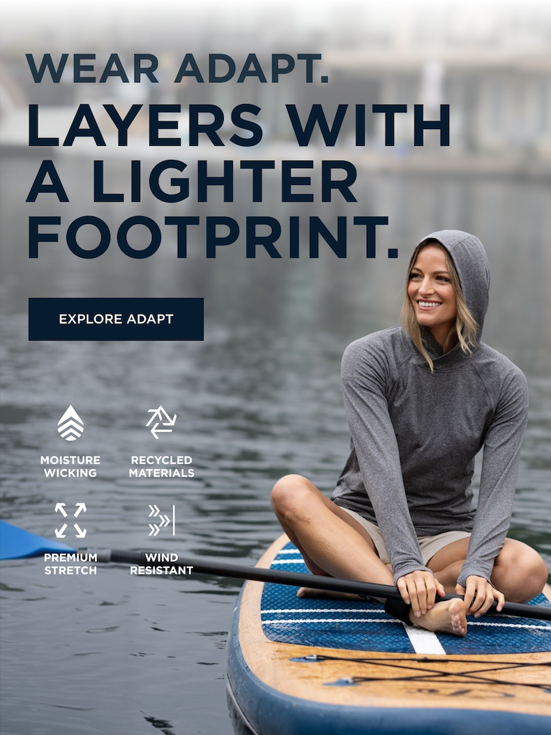 Woman wearing an Adapt pullover while paddle boarding | Explore Adapt