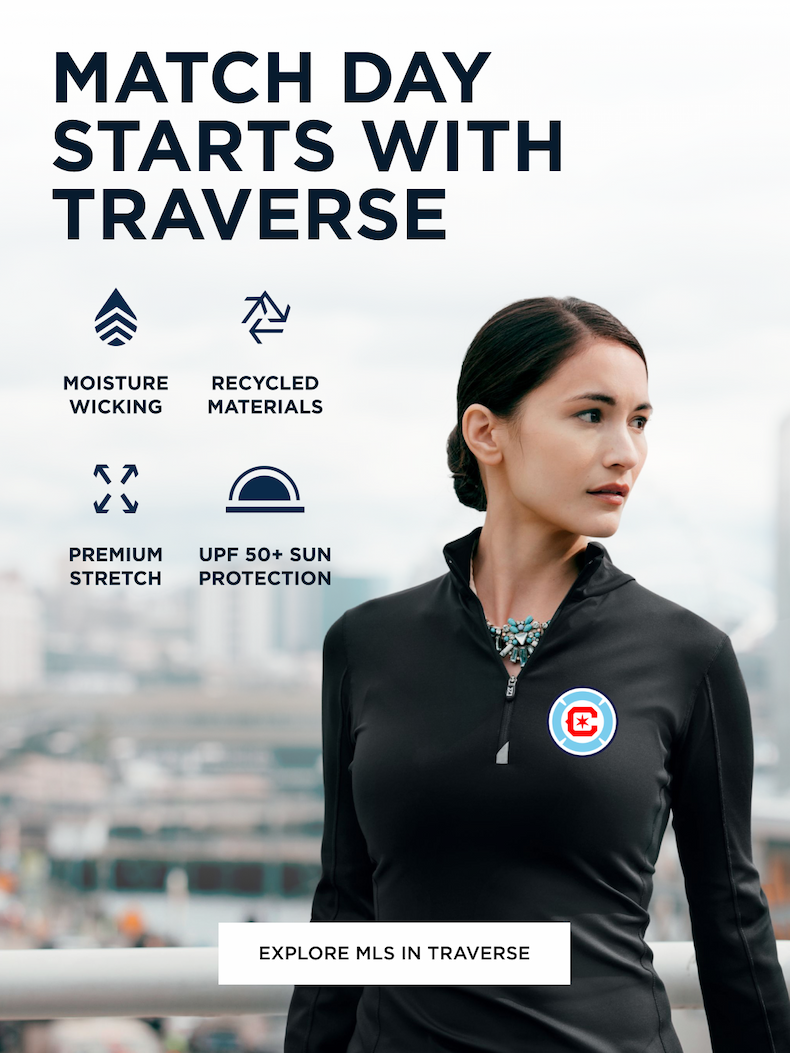 Woman wearing black zip up sweater looking over the city skyline | Explore Traverse