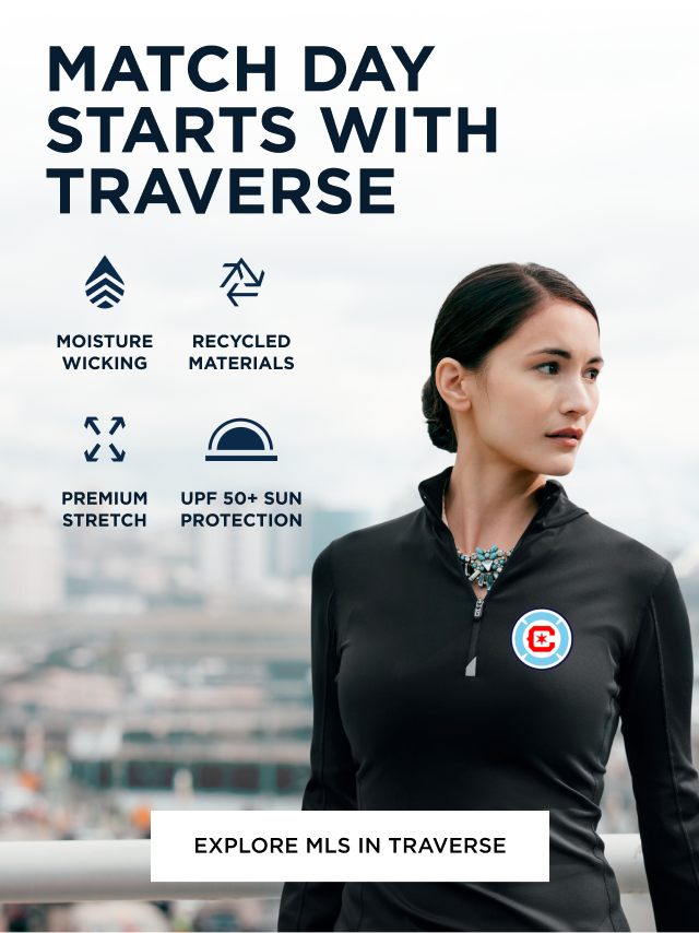 Woman wearing black Traverse zip up looking over the city skyline | Explore Traverse