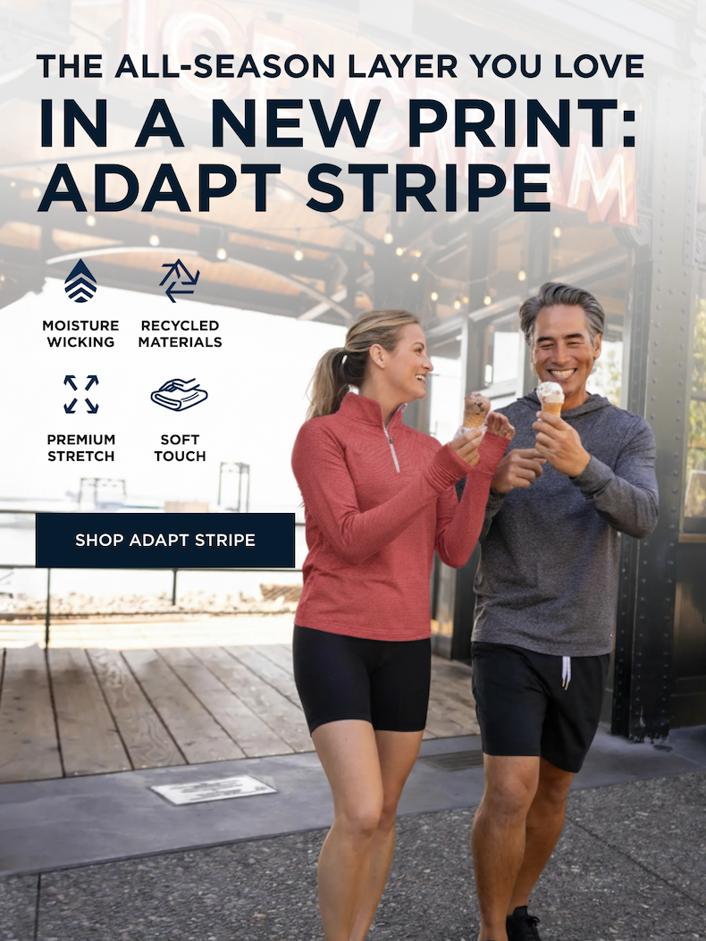 Woman wearing a pink Adapt Stripe quarter zip and man wearing a dark grey Adapt Stripe pullover eating ice cream cones on the boardwalk | Shop Adapt Stripe