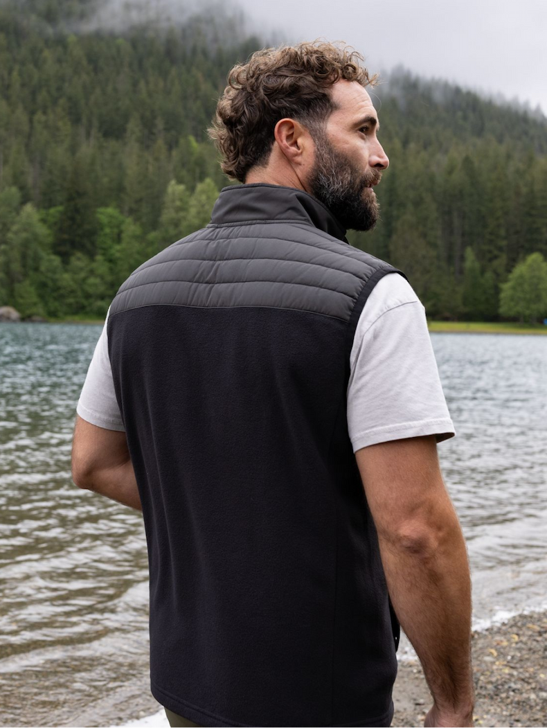 Man wearing the Woodland Vest by a lake