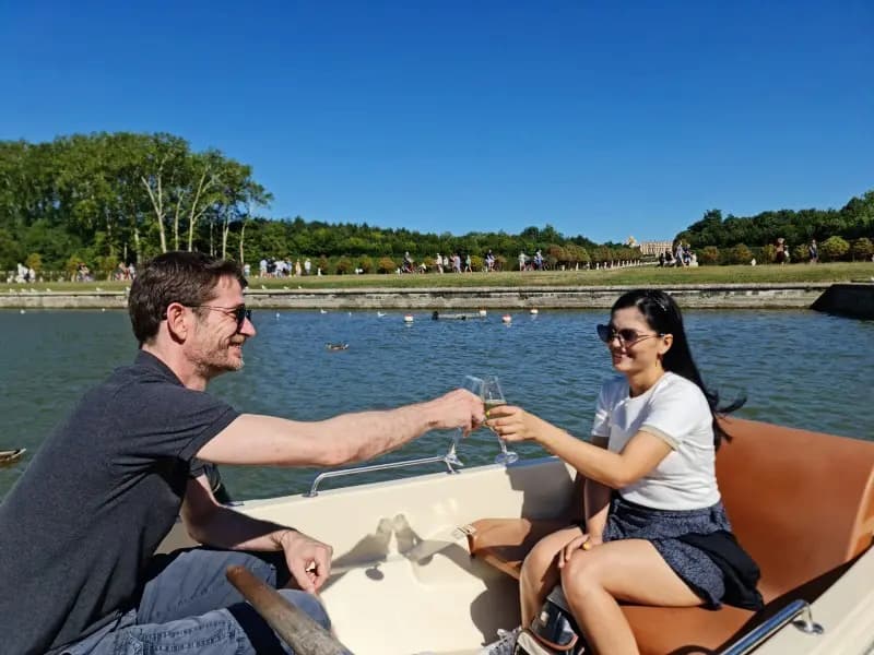 sipping champagne in a rowboat in Versailles gardens