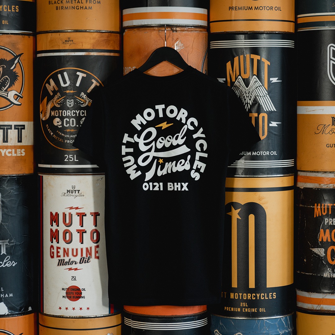 The new Mutt 'Good Times' tee on a hanger in with a background of custom Mutt oil cans
