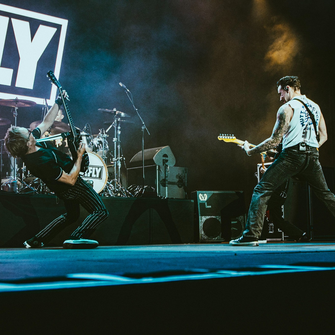 Danny Jones & Tom Fletcher of McFly rocking out on stage while Danny wears one of the new Mutt tees
