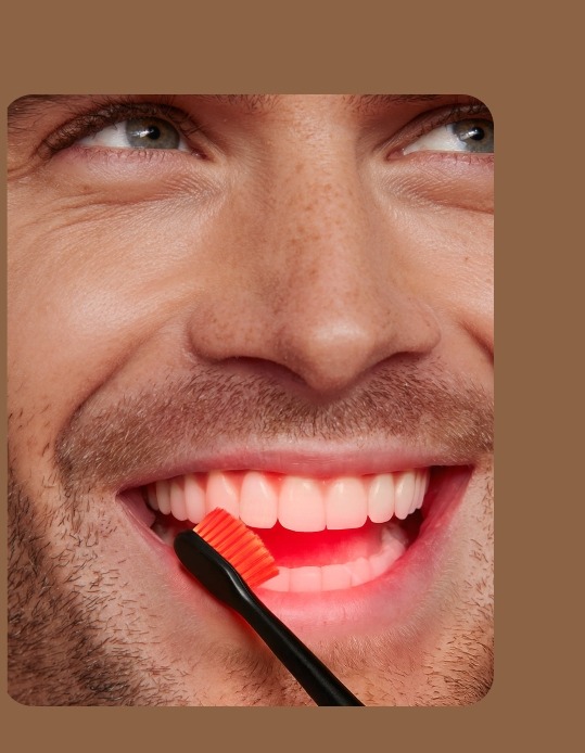 A man using Bon Charge Red Light Toothbrush