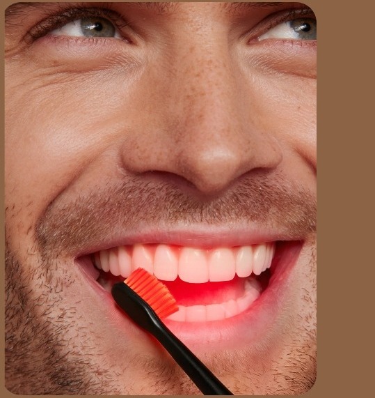 A man using Bon Charge Red Light Toothbrush