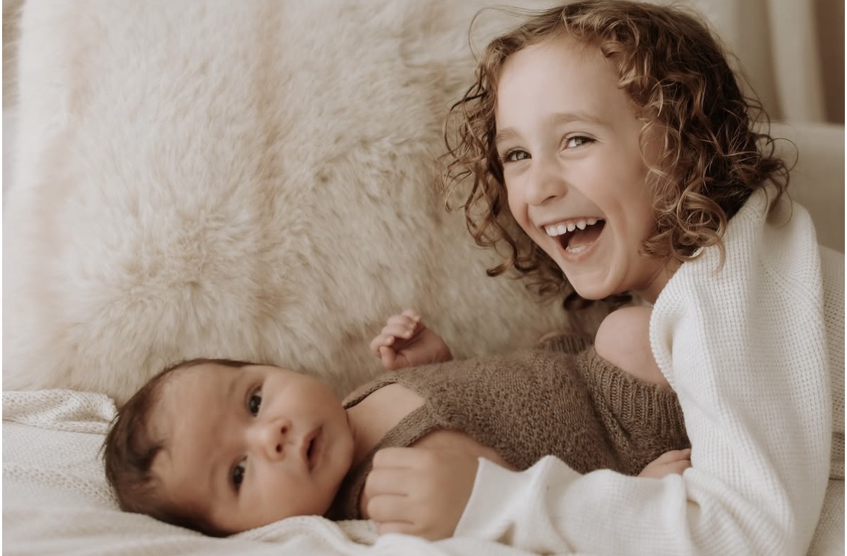 Aston and Mason cuddled up together