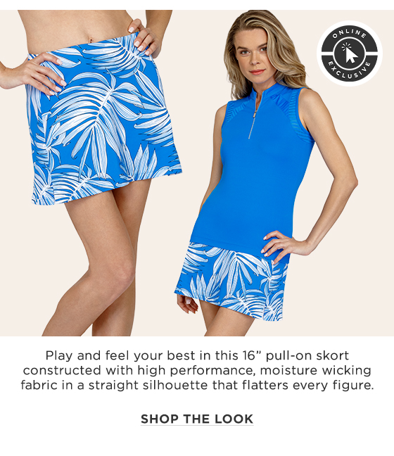 Woman in a sleeveless blue top and a blue skort with a white palm leaf print
