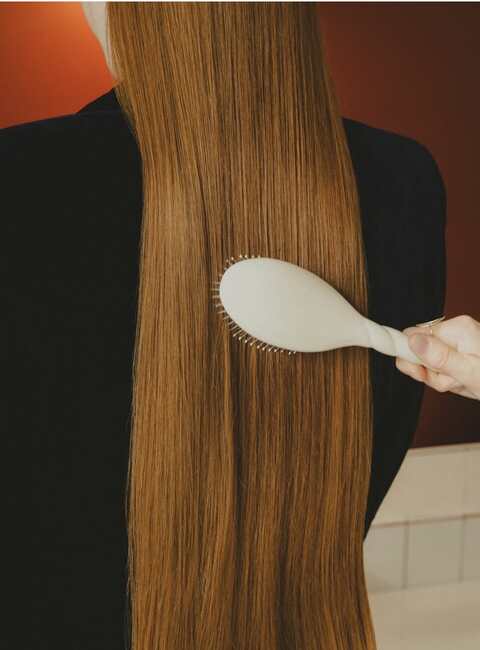 Glossy, healthy hair being brushed