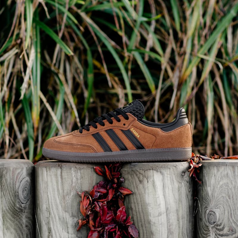 an image of a pair of brown and black sneakers sitting on a wooden post