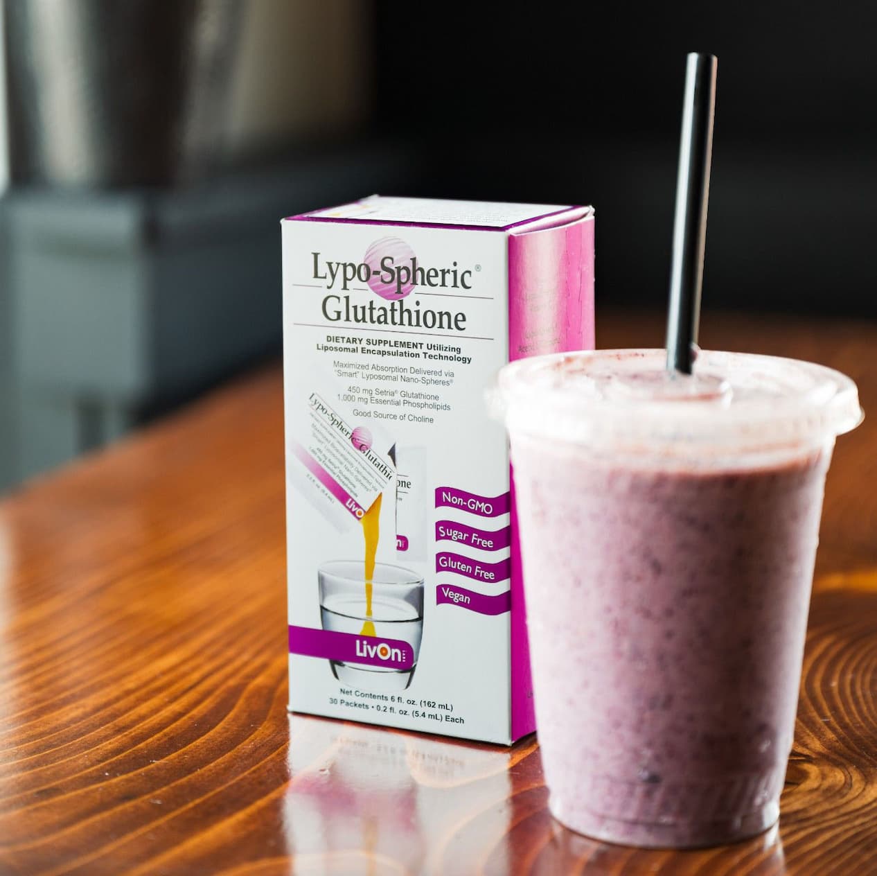 carton of lypo-spheric® glutathione on a table with purple smoothie