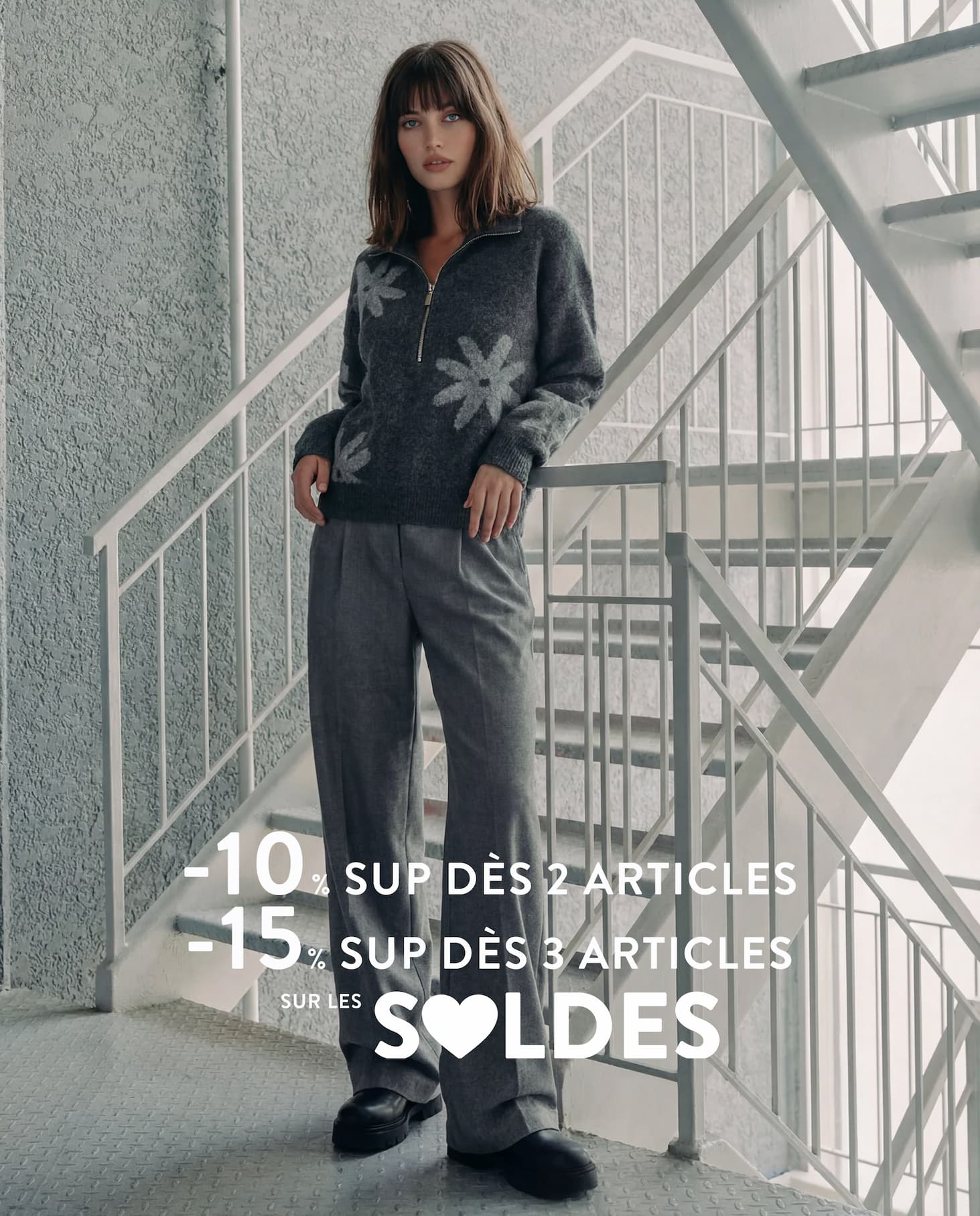 an image of a woman wearing a blue sweater and hat