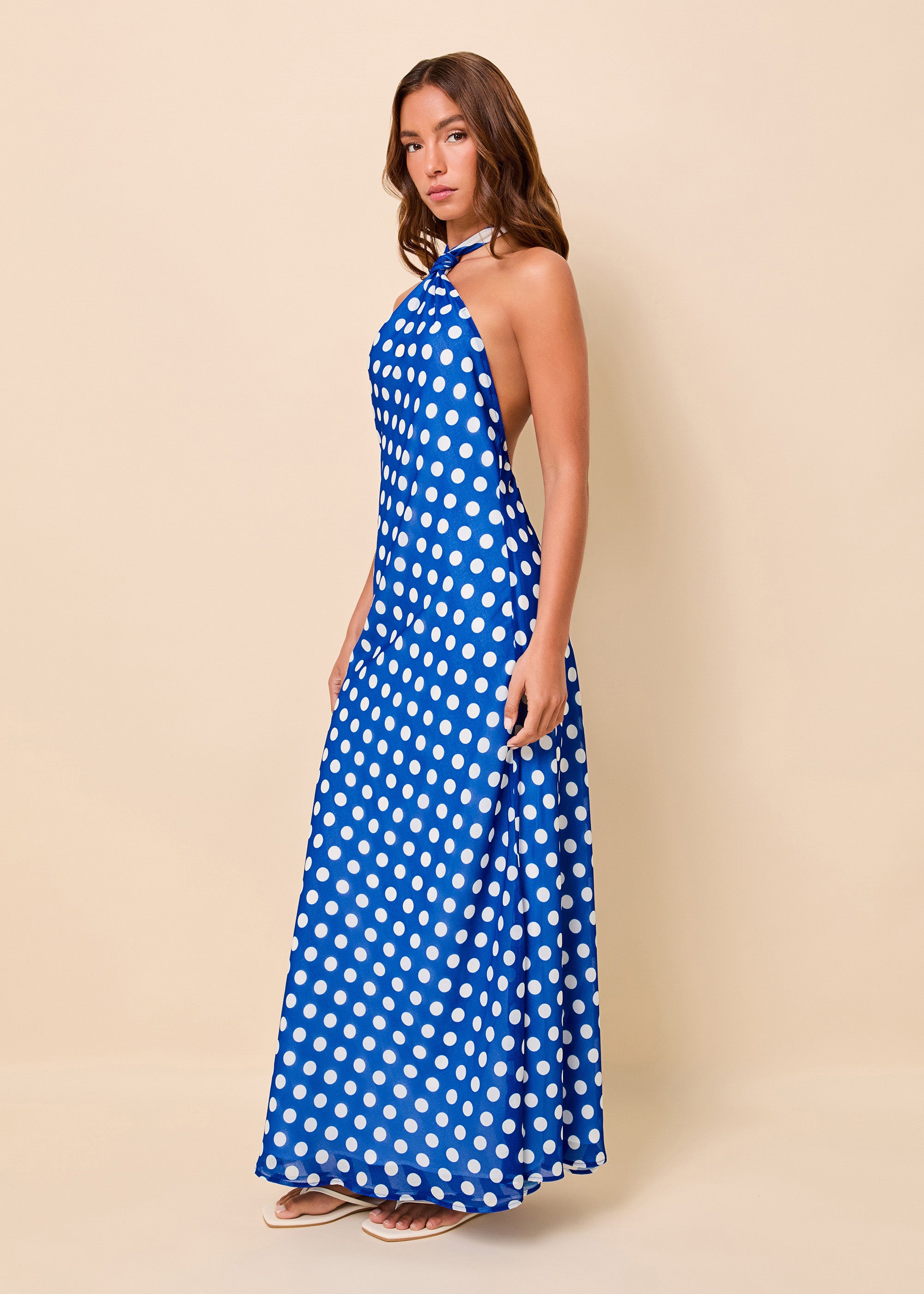 woman in blue and white polka dot halter dress