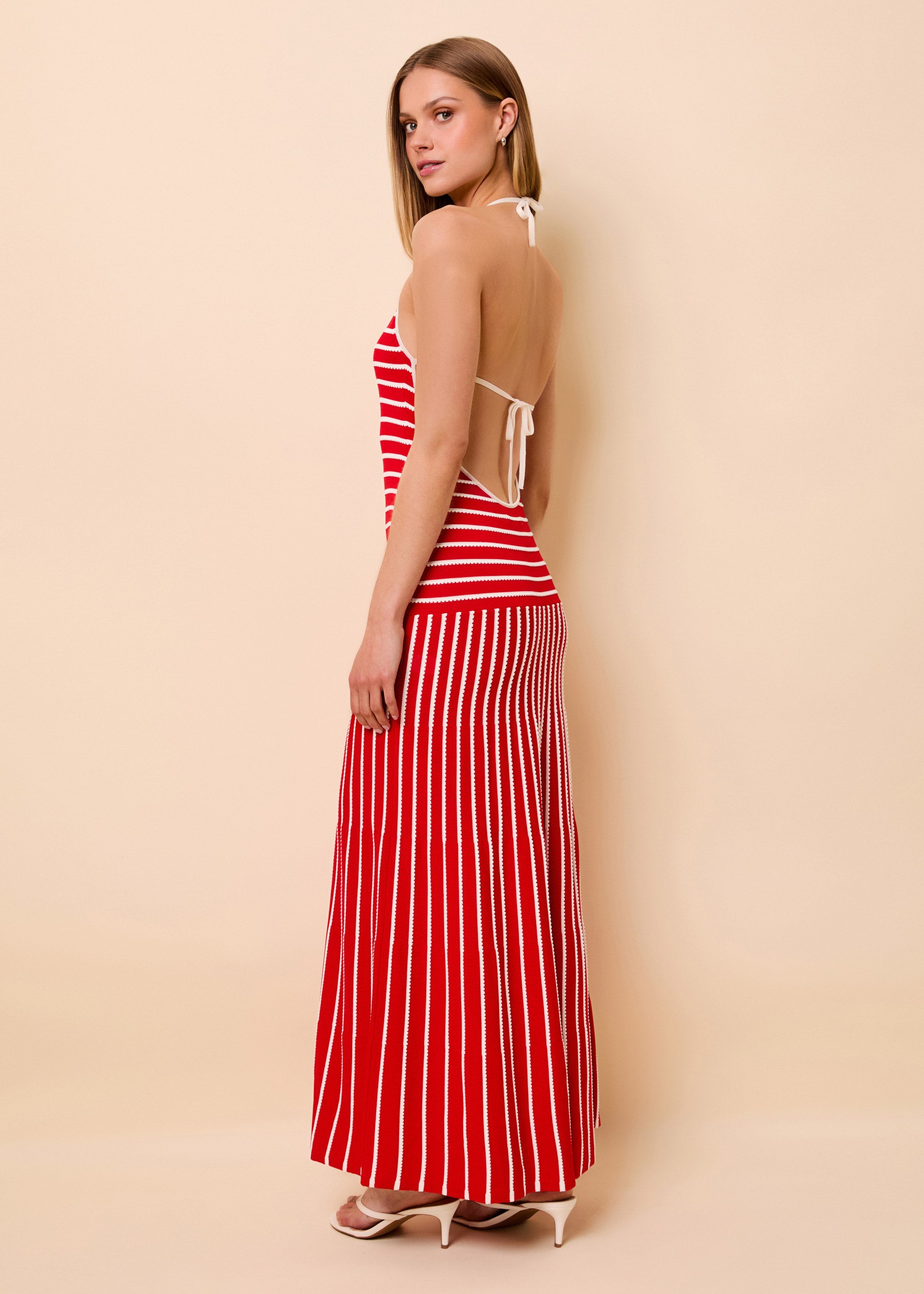 woman in red and white open back knit full length dress
