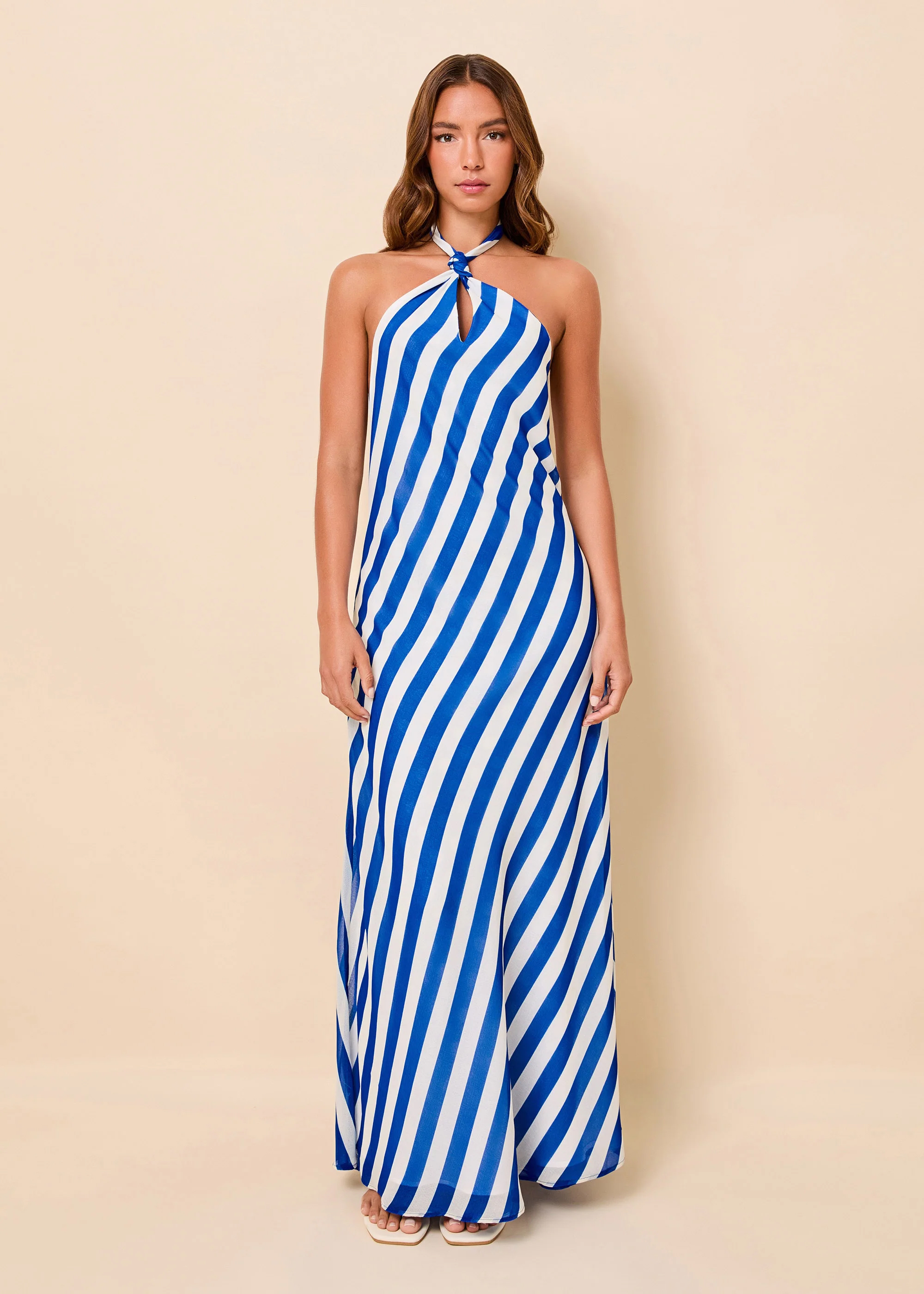 woman in blue and white striped dot halter dress