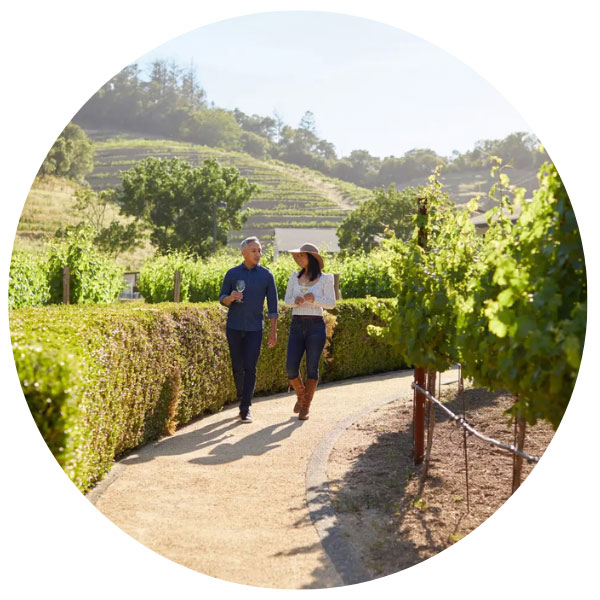 couple walking through the vineyards at Pine Ridge