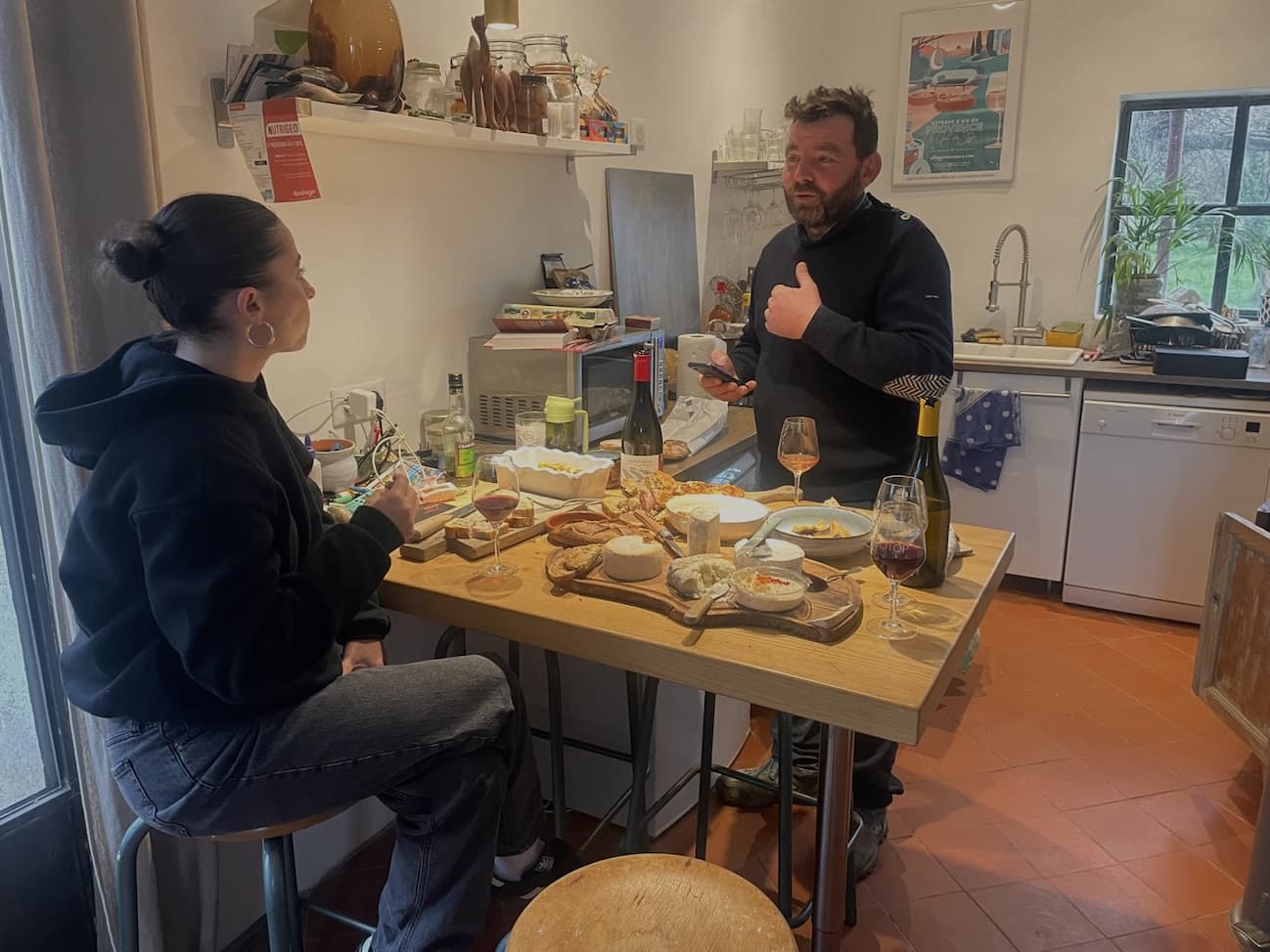 an image of a man and woman sitting at a table with food