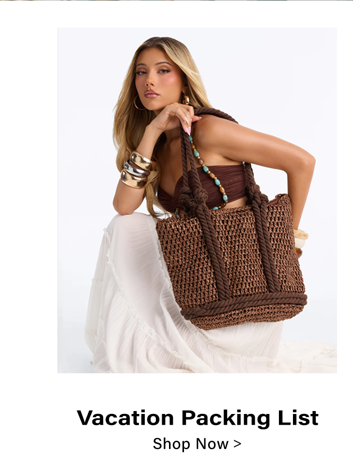 Brown woven straw tote bag held by woman. Perfect beach, vacation, summer fashion accessory. Shop your packing list.