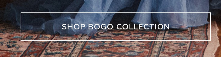 Blue fabric dress flowing onto an ornate patterned rug with a foot peeking out. Shop our BOGO Collection for stylish sale items.