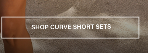 Sandy beach banner overlay reading "SHOP CURVE SHORT SETS" in white, linking to a category page promoting trendy plus size summer co-ord sets.