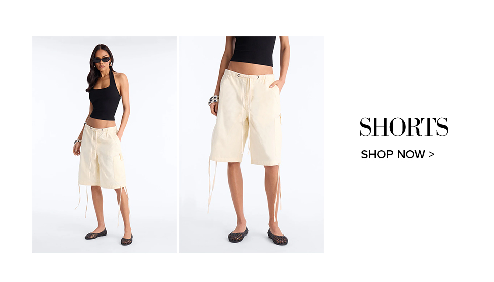 Model in black halter top and cream drawstring cargo shorts, promoting trendy women's shorts. Shop the latest styles now.