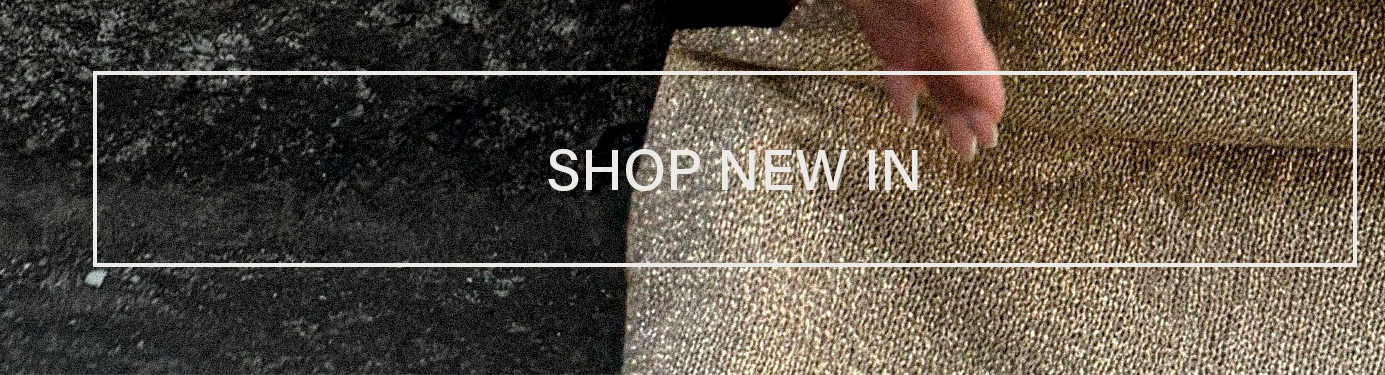 SHOP NEW IN: Golden textured fabric with a hand. Discover new arrivals.