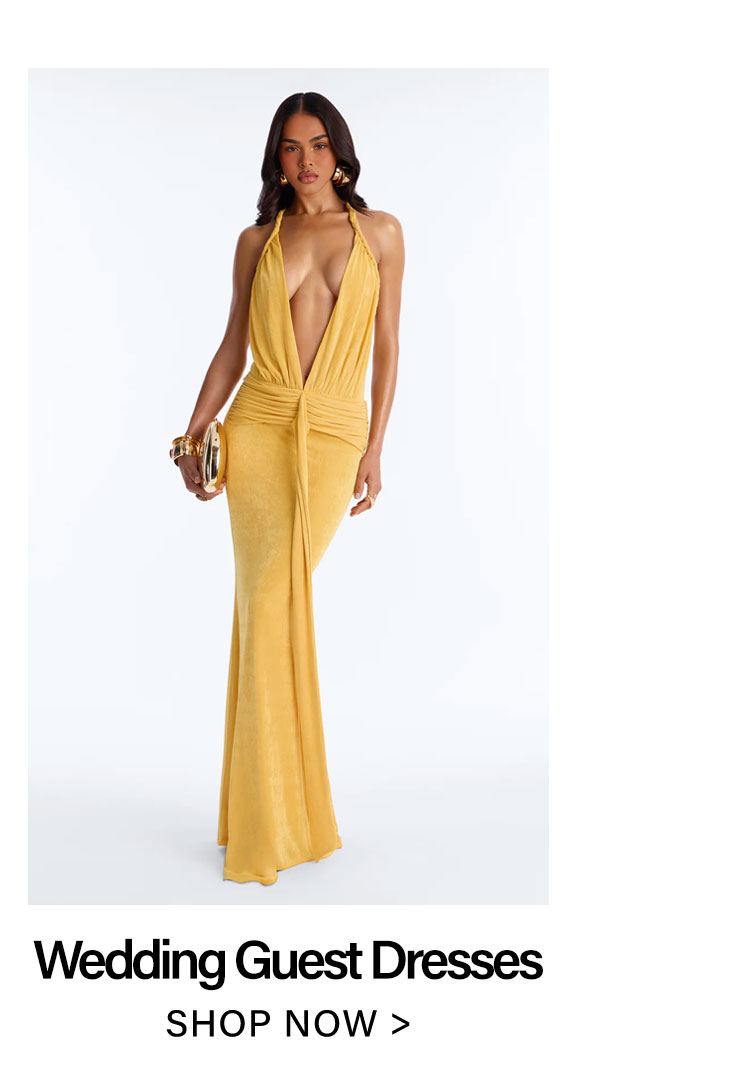 Marigold plunging V-neck maxi wedding guest dress with ruched waist, modeled by a woman holding a gold clutch.