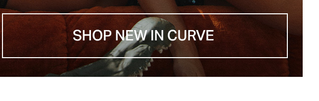 Close-up of model in warm red-brown textured clothing, highlighting new arrivals in the Curve collection. Shop inclusive fashion.