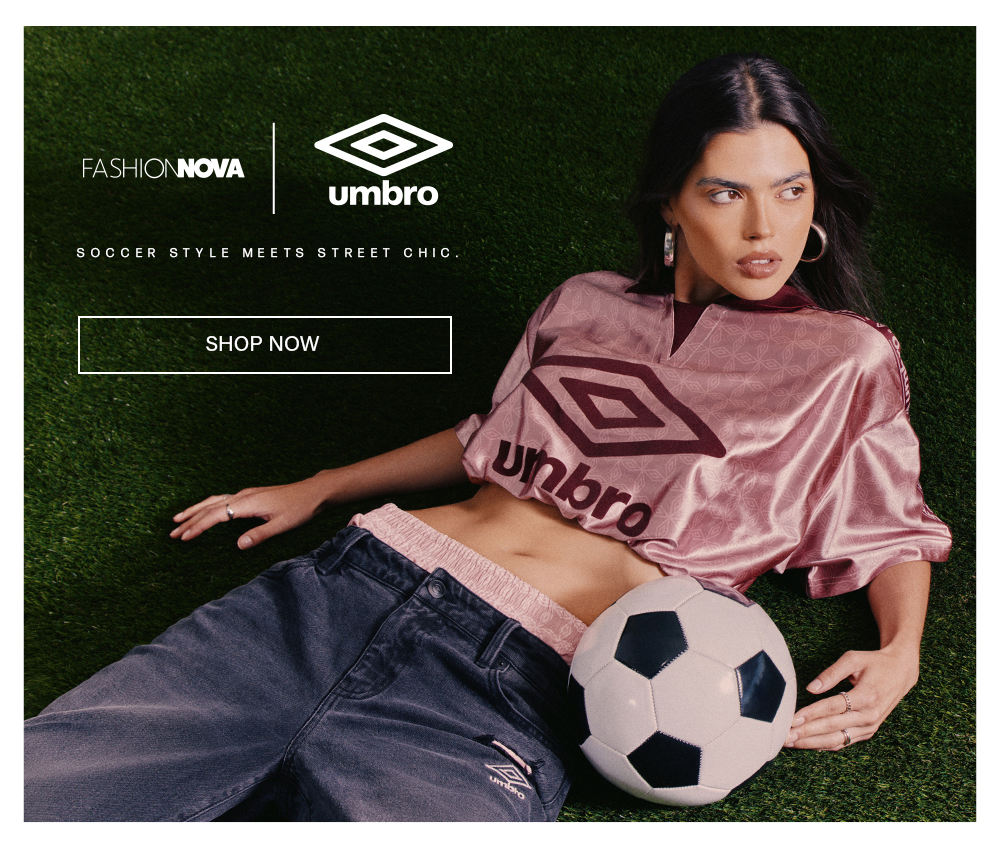 Fashion Nova x Umbro. Woman in pink soccer crop top & baggy jeans on grass with soccer ball. Modern street chic fashion. Shop now.