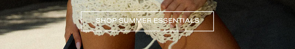 Close-up of cream crochet knit shorts with a white 'Shop Summer Essentials' banner to promote the brand's new warm-weather fashion collection.