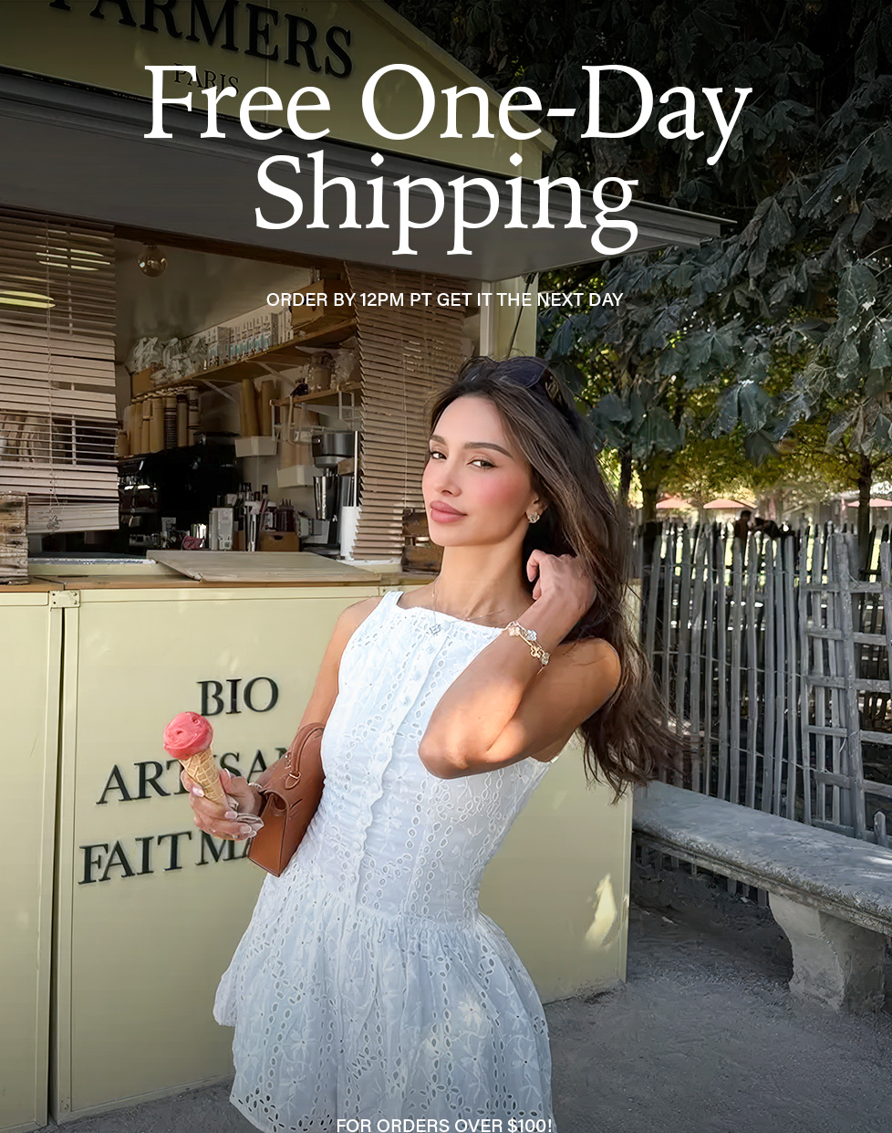Stylish woman in white eyelet mini-dress with ice cream, promoting free one-day shipping on orders over $100 for fashion. Order by 12 PM PT.