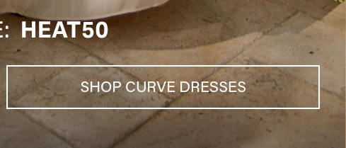White-bordered 'Shop Dresses' button with white text, against dark grass and light paving. Use code to browse new dress arrivals and styles.