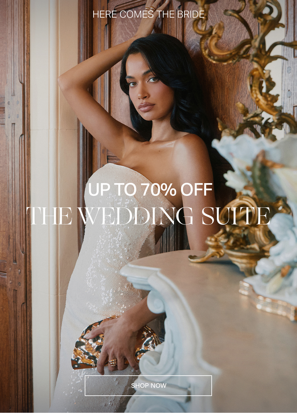 Woman in a dazzling white sequin strapless gown, holding a gold clutch, promoting The Wedding Suite sale with up to 70% off bridal dresses and gowns.