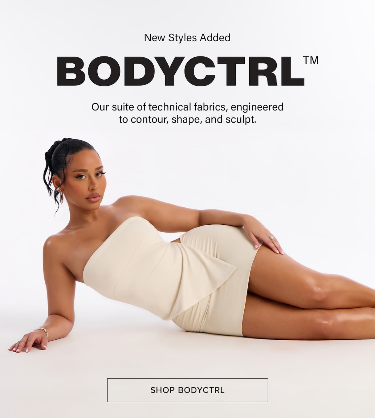 Woman models new BODYCTRL beige strapless mini-dress. Engineered with technical fabrics to contour, shape, and sculpt. Shop new styles.
