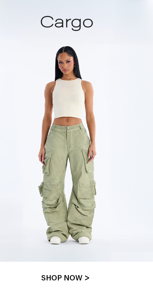Stylish woman models oversized sage green cargo pants with a cream ribbed crop top. Discover trendy women's cargo fashion now!